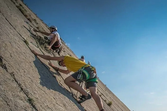 Foto di un gruppo di persone che praticano climbing, una delle attività sportive vicine a larocca camping